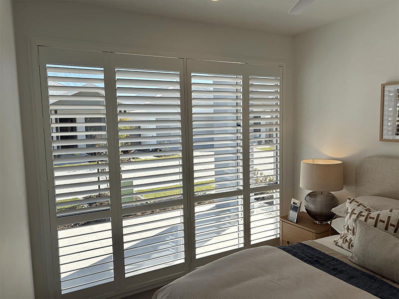 Bedroom with tall shutters