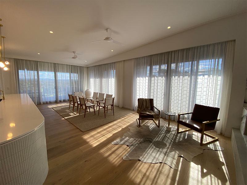 Large wooden living area with curtains
