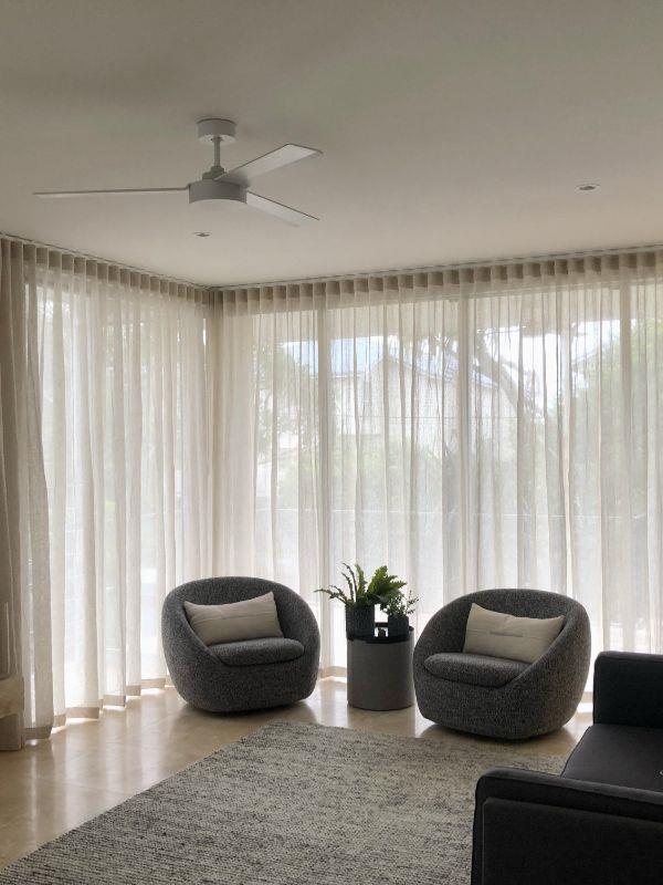 new curtains with 2 armchairs in front